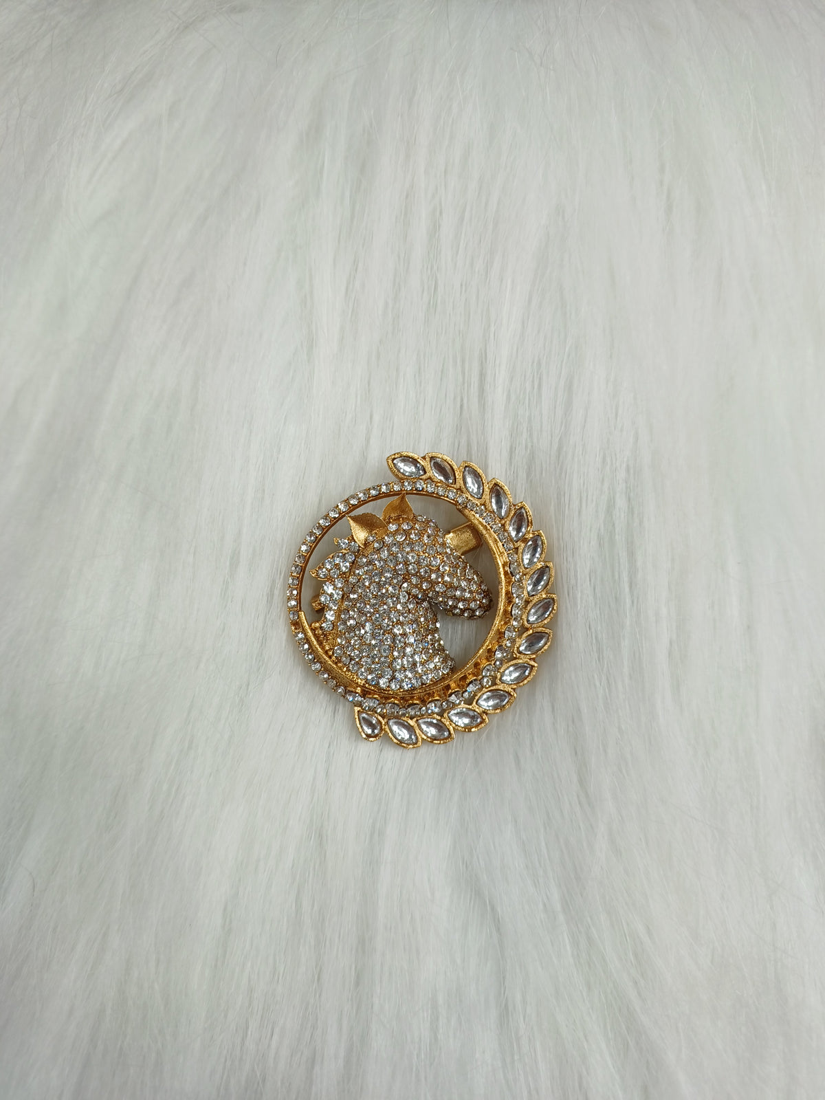 Golden metal and stonework horse brooch with intricate design, featuring a detailed horse figure and elegant craftsmanship.