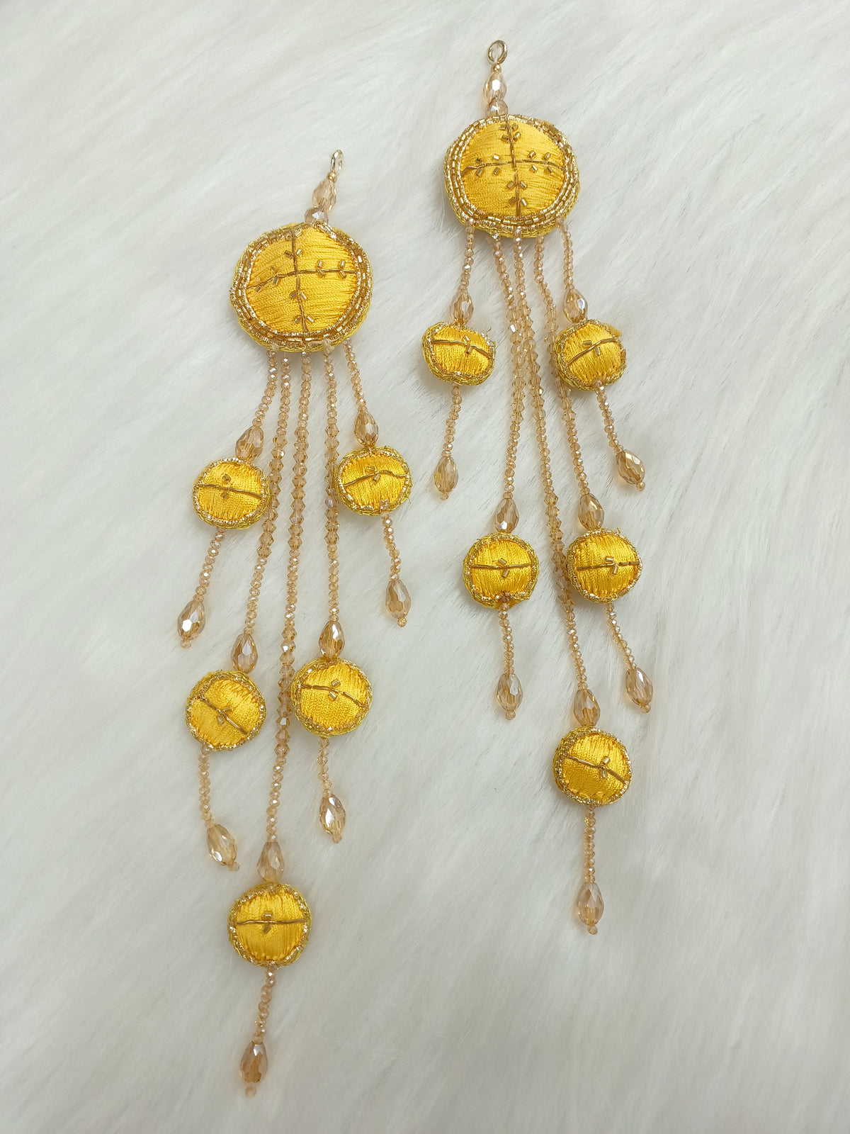 Yellow latkan with Zardosi cutdana and crystal handwork, showcasing intricate embroidery and decorative tassels.