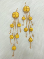Yellow latkan with Zardosi cutdana and crystal handwork, showcasing intricate embroidery and decorative tassels.