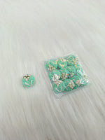 Sea green crochet handwork button by Lace Hut, featuring intricate textured design and multiple sewing holes for clothing embellishment.