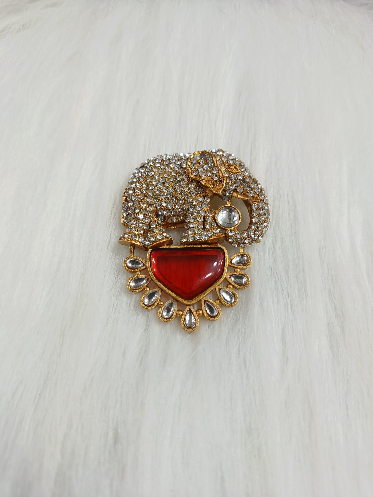 Golden metal and stonework elephant brooch featuring intricate design, handcrafted by Lace Hut.