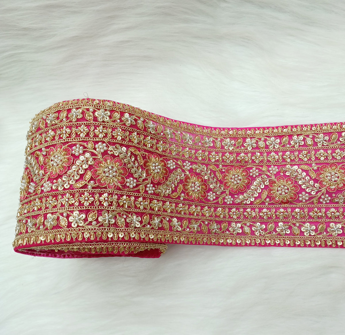 Rani pink lace with cutdana and moti handwork on net base, detailed close-up of intricate embroidery by Lace Hut.
