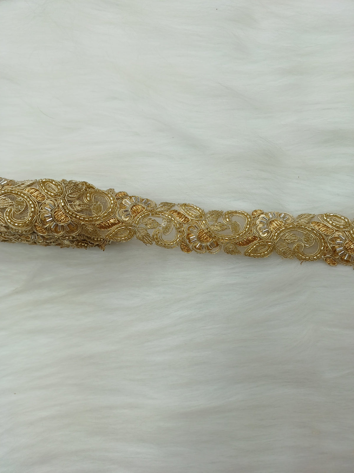 Golden Cutdana handwork lace with intricate cutwork design, crafted by Lace Hut for elegant fabric embellishments.