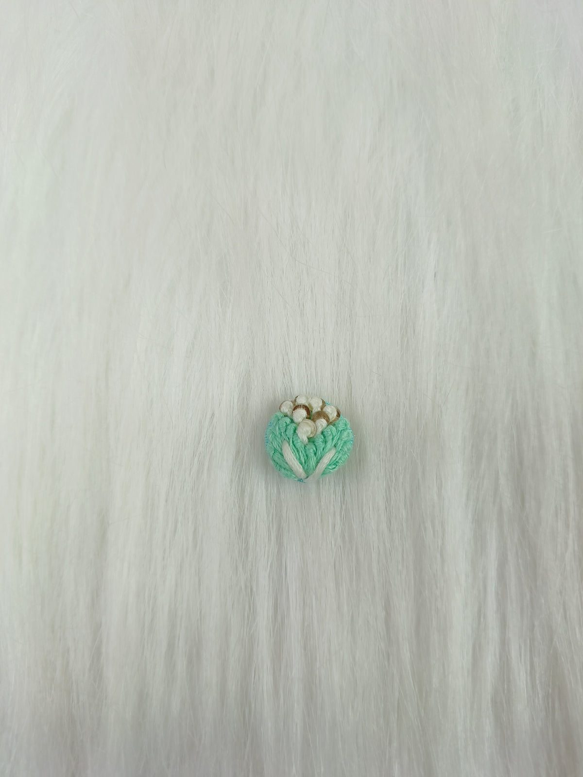 Sea green crochet handwork button from Lace Hut, featuring intricate design and glossy finish for decorative use.
