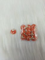 Crochet peach button from Lace Hut featuring intricate handwork, ideal for craft projects and decorative clothing accents.