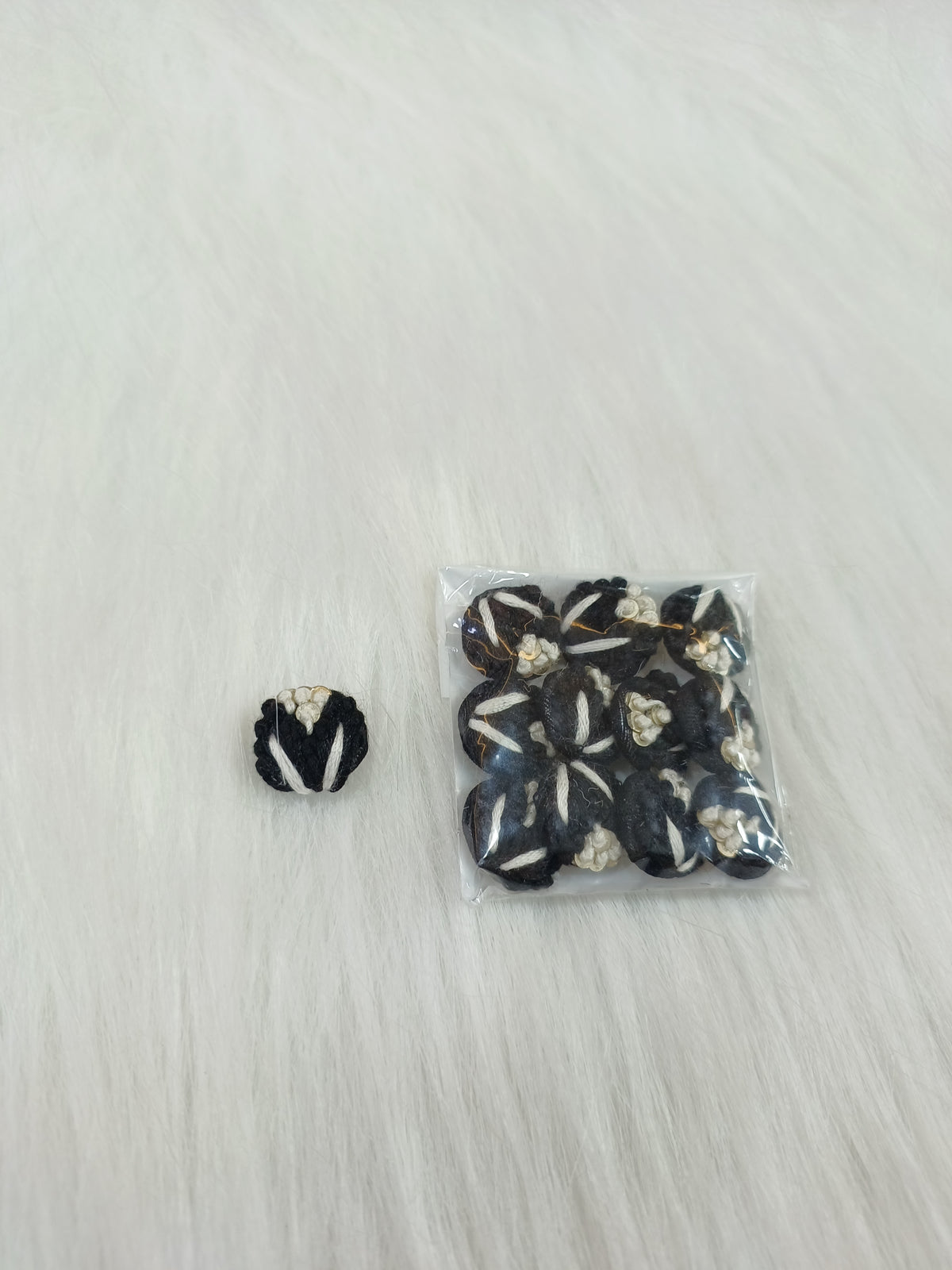 Black crochet handwork button with intricate lace design from Lace Hut, suitable for clothing and craft projects.