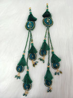 Bottle green lehenga latkan with cutdana and crystal handwork, featuring intricate embroidery and embellishments.