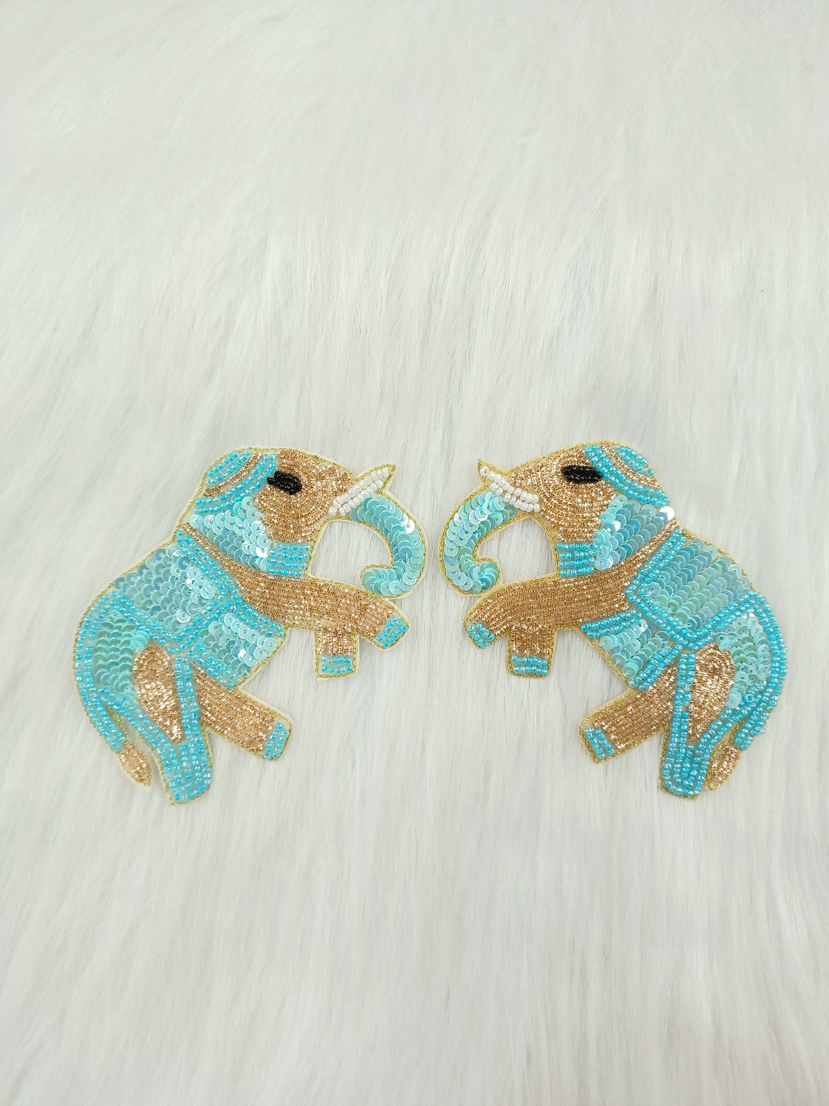 Aqua blue Zardosi poth and sequence handwork on fabric featuring an embroidered elephant patch by Lace Hut.