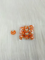 Orange crochet handwork button from Lace Hut with a decorative design, perfect for adding a handmade touch to clothing or crafts.