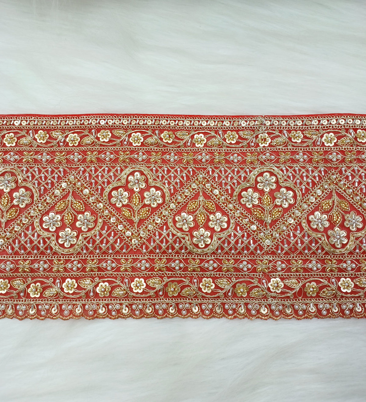 Red lace fabric with intricate cutdana and moti handwork on net base from Lace Hut, showcasing detailed embroidery and embellishments.