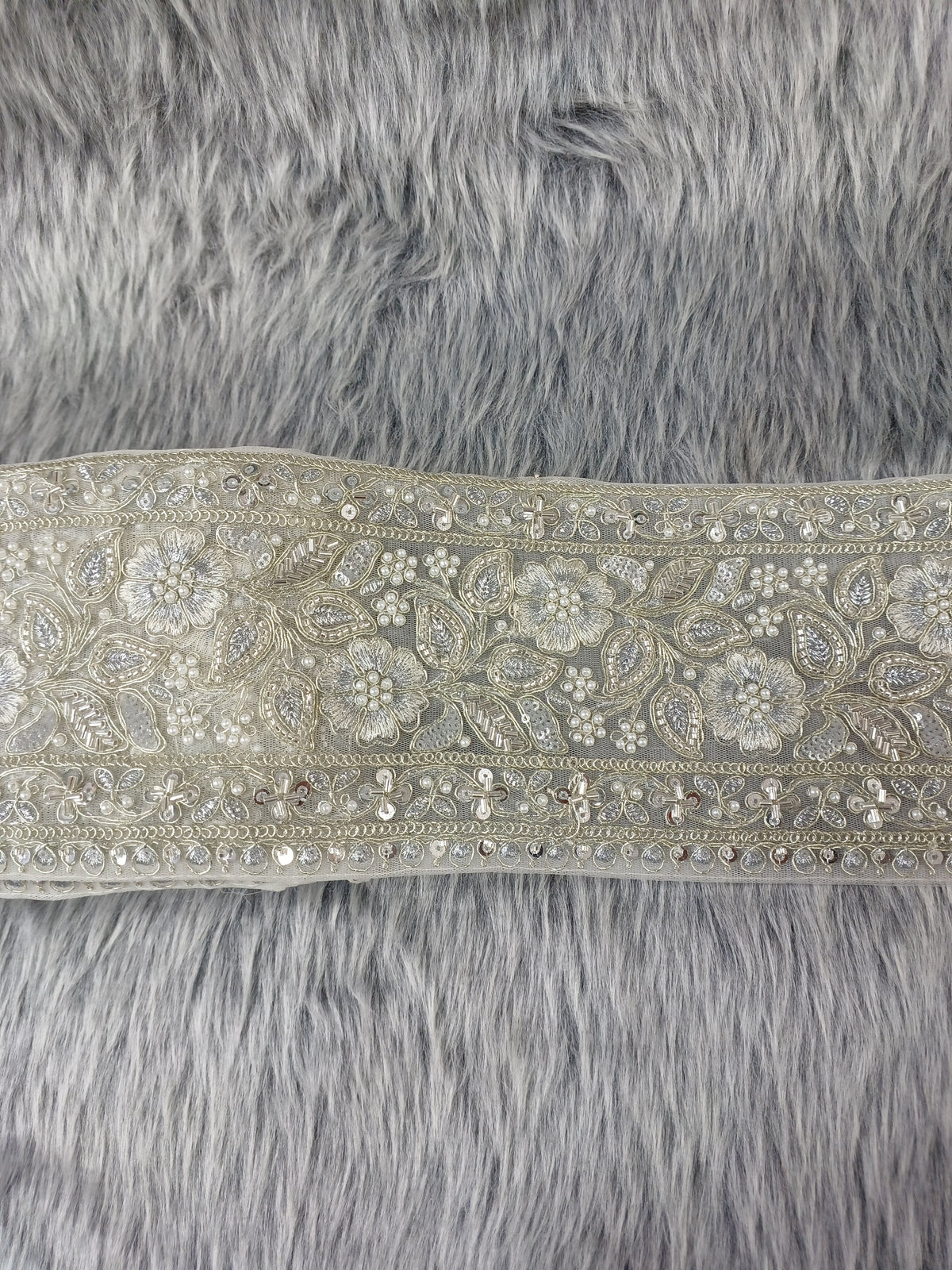 Silver lace with cutdana and moti handwork from Lace Hut, featuring intricate embroidery and delicate design.