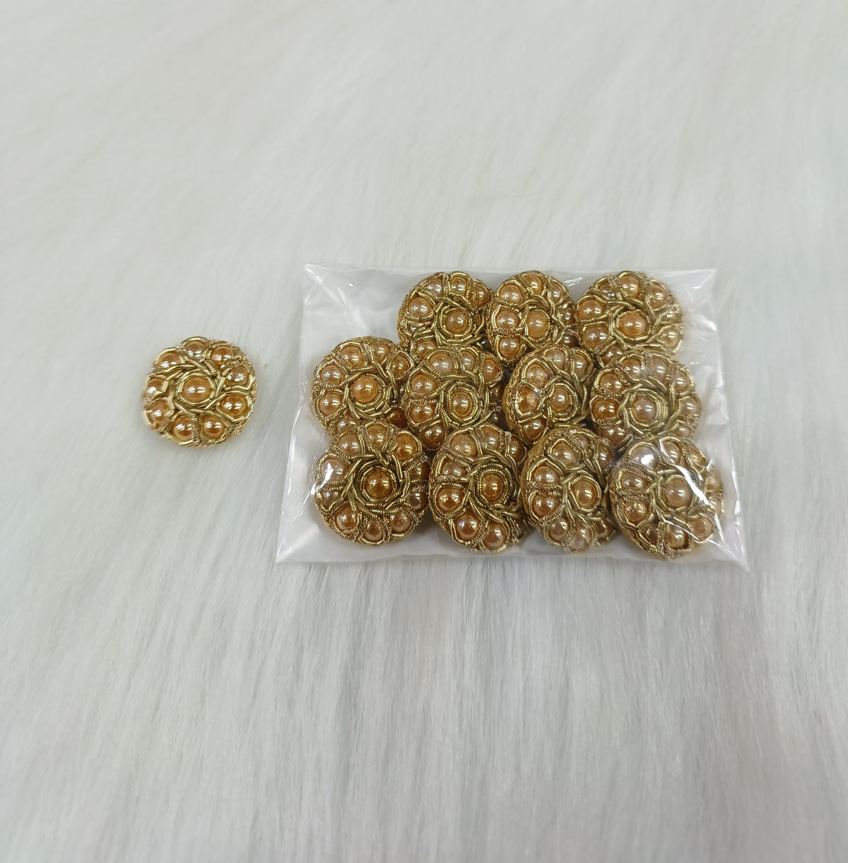 Dull golden Zardosi and moti handwork button with intricate embroidery from Lace Hut, suitable for traditional garments.