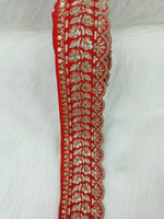 Red lace with intricate cutdana and jari handwork, showcasing detailed embroidery and delicate craftsmanship by Lauce-Hut.