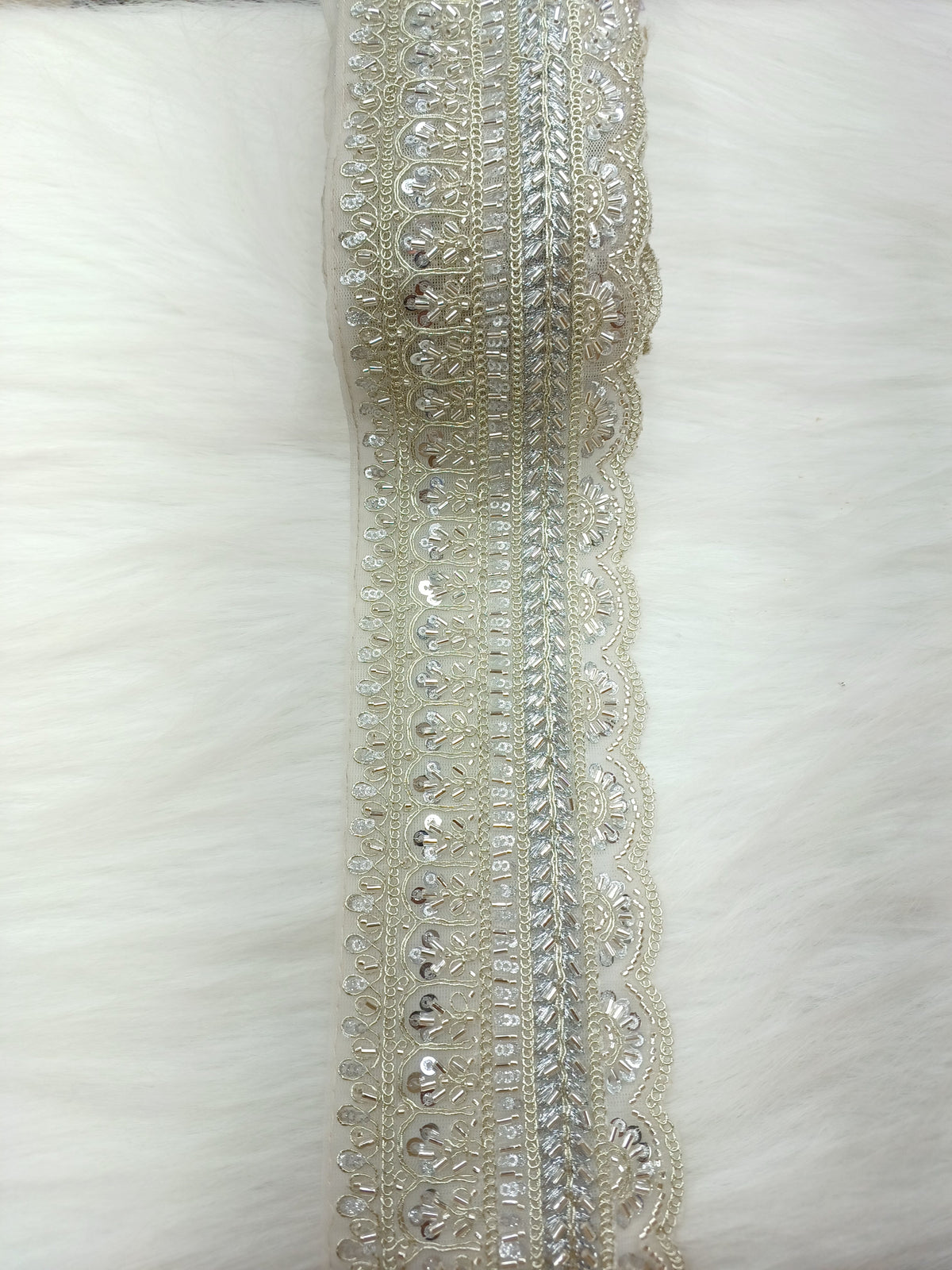 Silver lace with intricate cutdana handwork, detailed floral patterns, and delicate embroidery from Lace Hut.