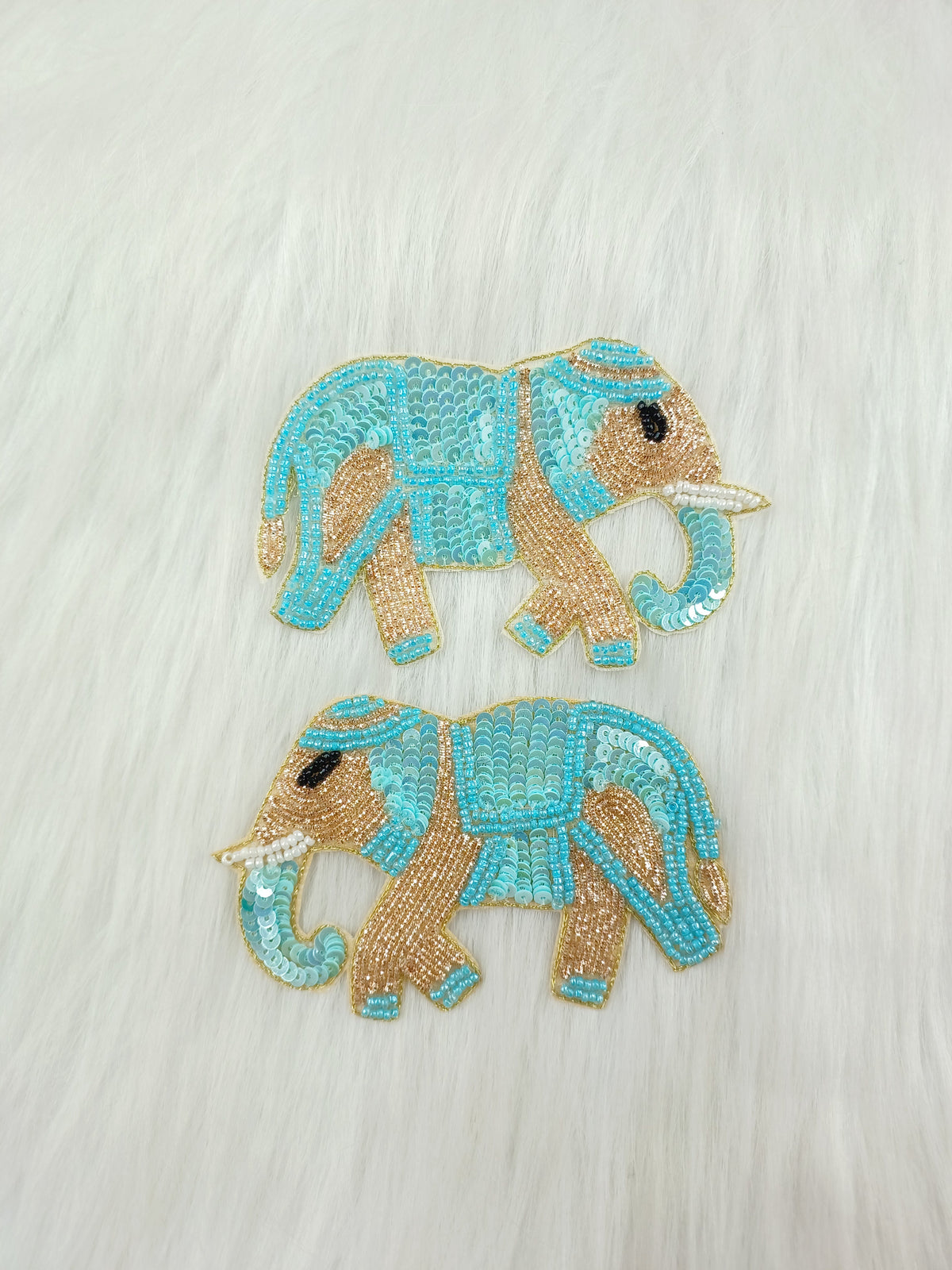 Aqua blue Zardosi poth and sequence handwork elephant patch from Lace Hut, detailed embroidery on fabric.
