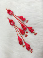 Reddish pink lehenga with Cutdana and crystal handwork, featuring decorative latkan details, from Lace Hut.