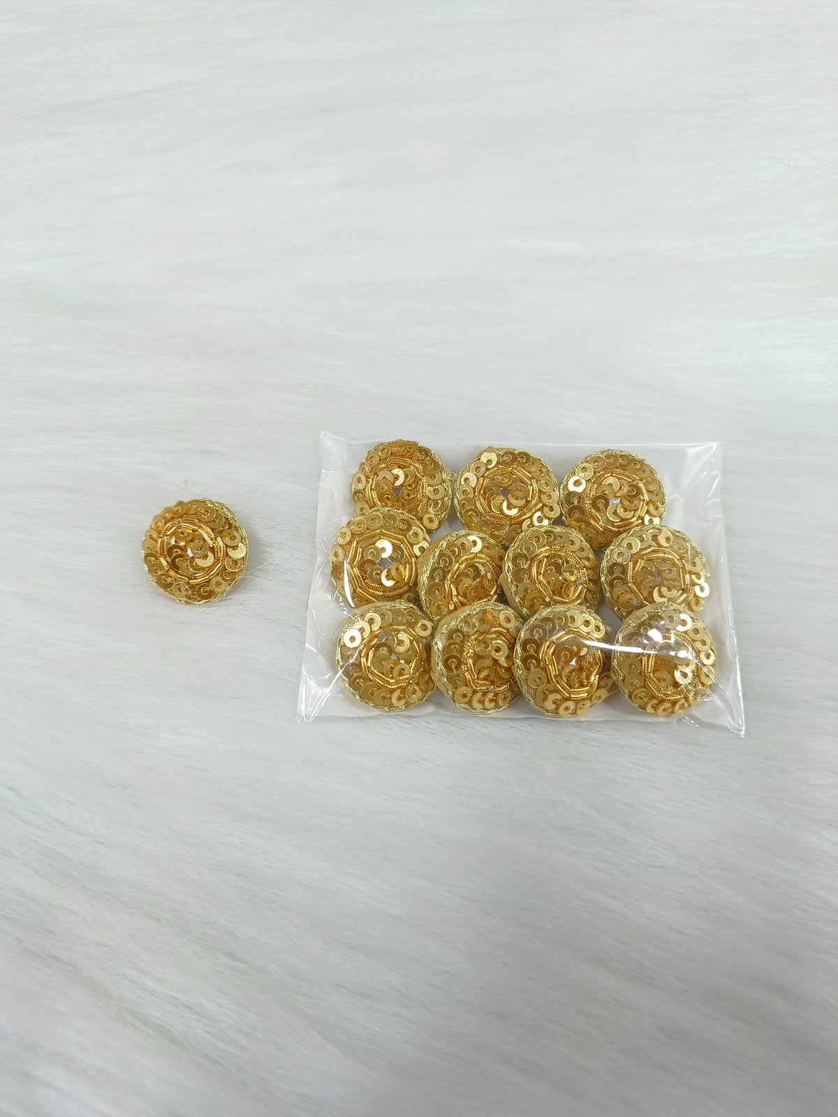 Bright golden Zardosi and sequence handwork button with intricate design, designed for traditional or bridal attire.