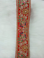 Peacock design lace with Cutdana and moti handwork on red base, vibrant multi-color floral embroidery, intricate and decorative.
