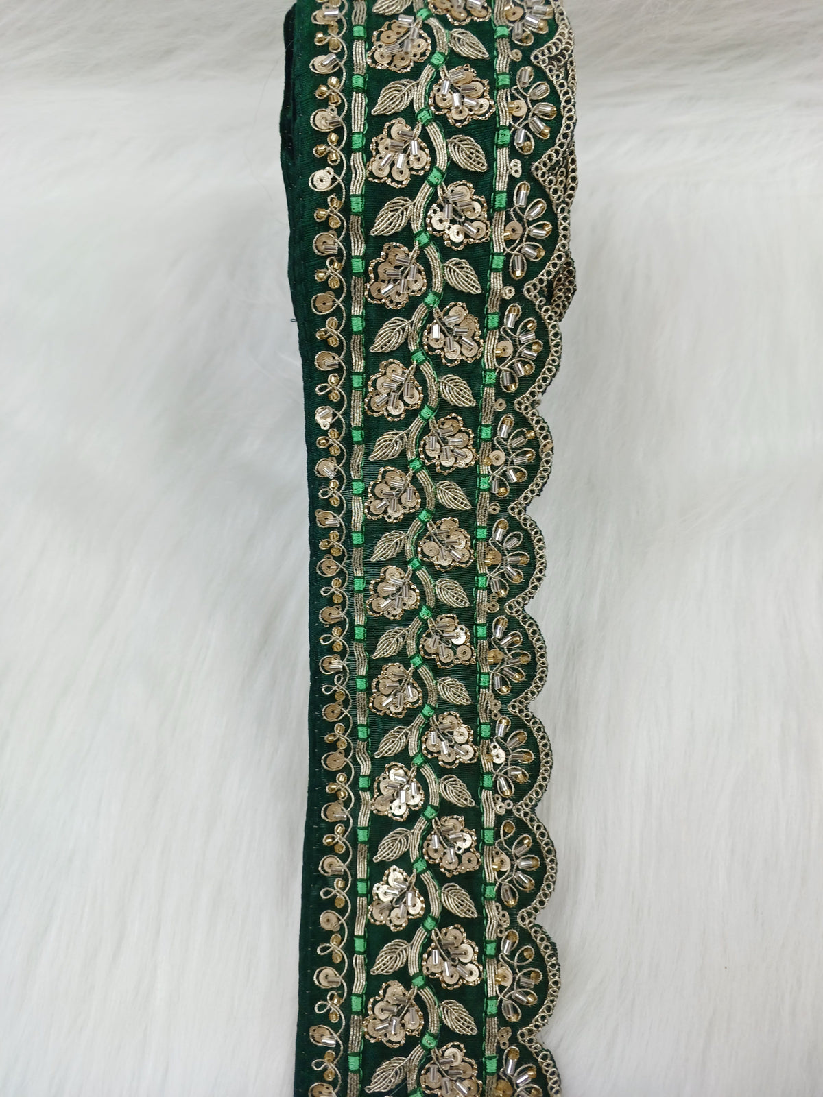 Bottle green lace with intricate cutdana jariwork, detailed embroidery, and delicate floral patterns from Luce-Hut.