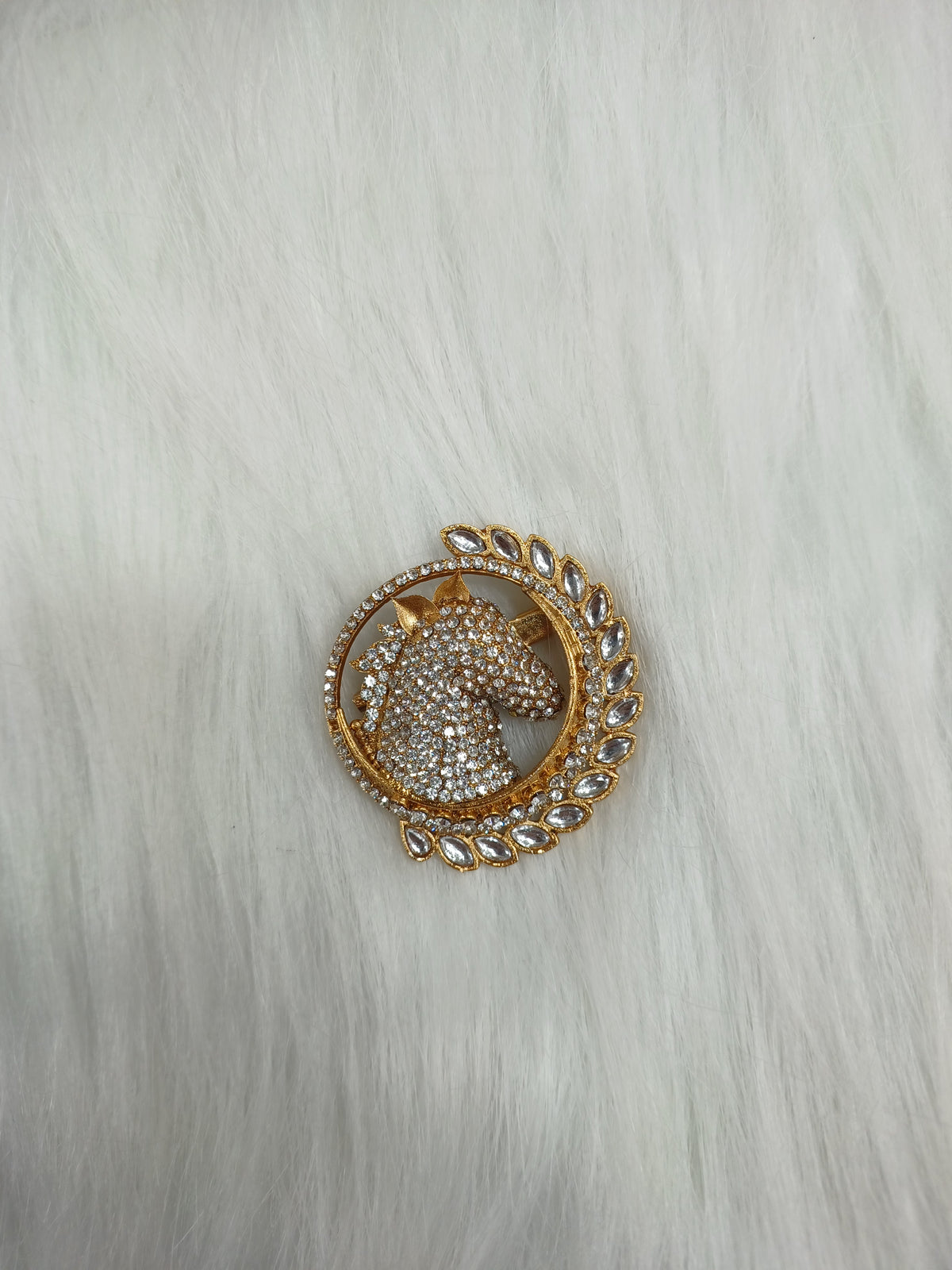 Golden metal and stonework horse brooch from Lace Hut with intricate detailing and elegant design.