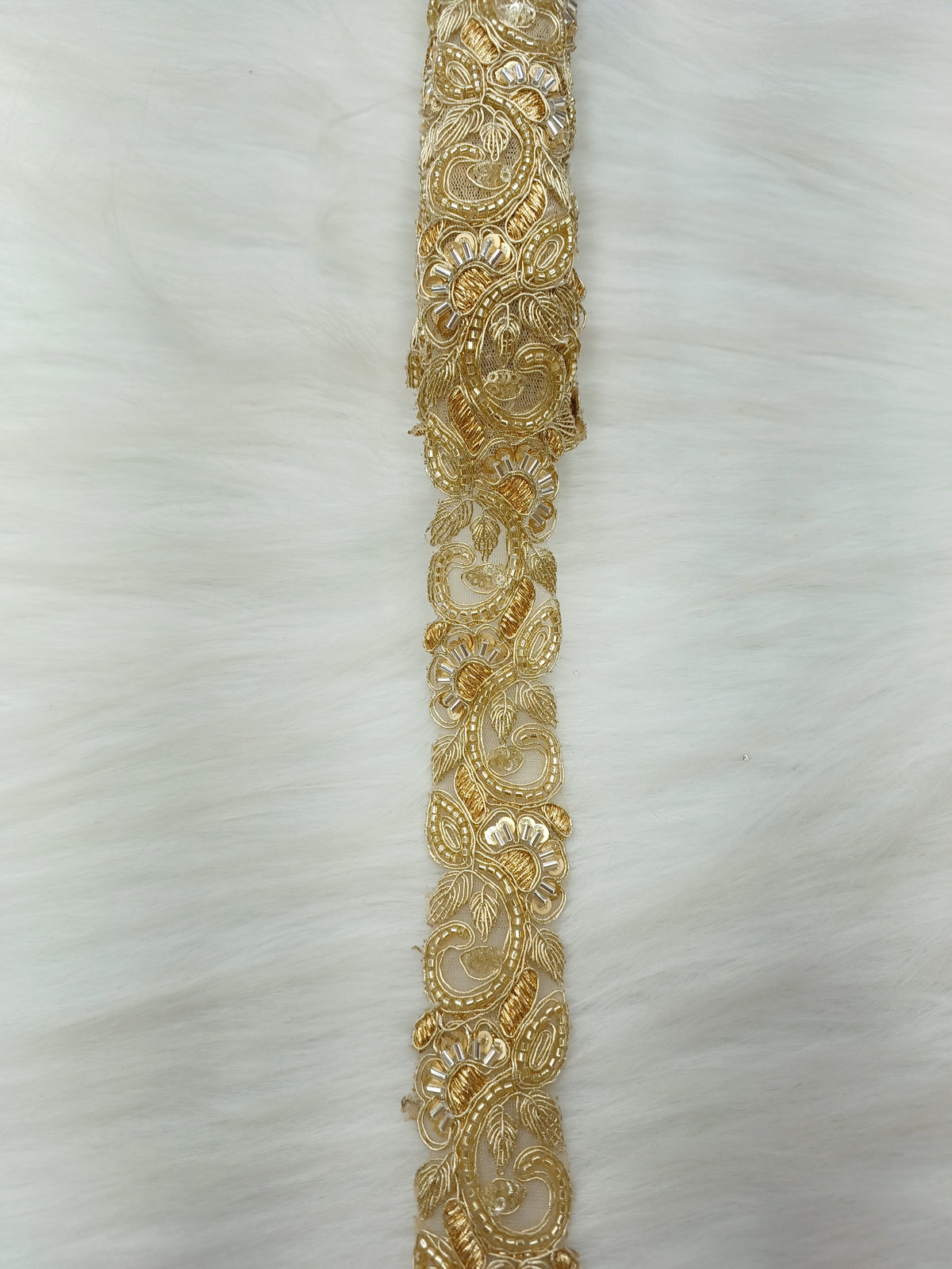Golden cutdana handwork lace with intricate cutwork design from Lace Hut, showcasing detailed craftsmanship and elegant pattern.