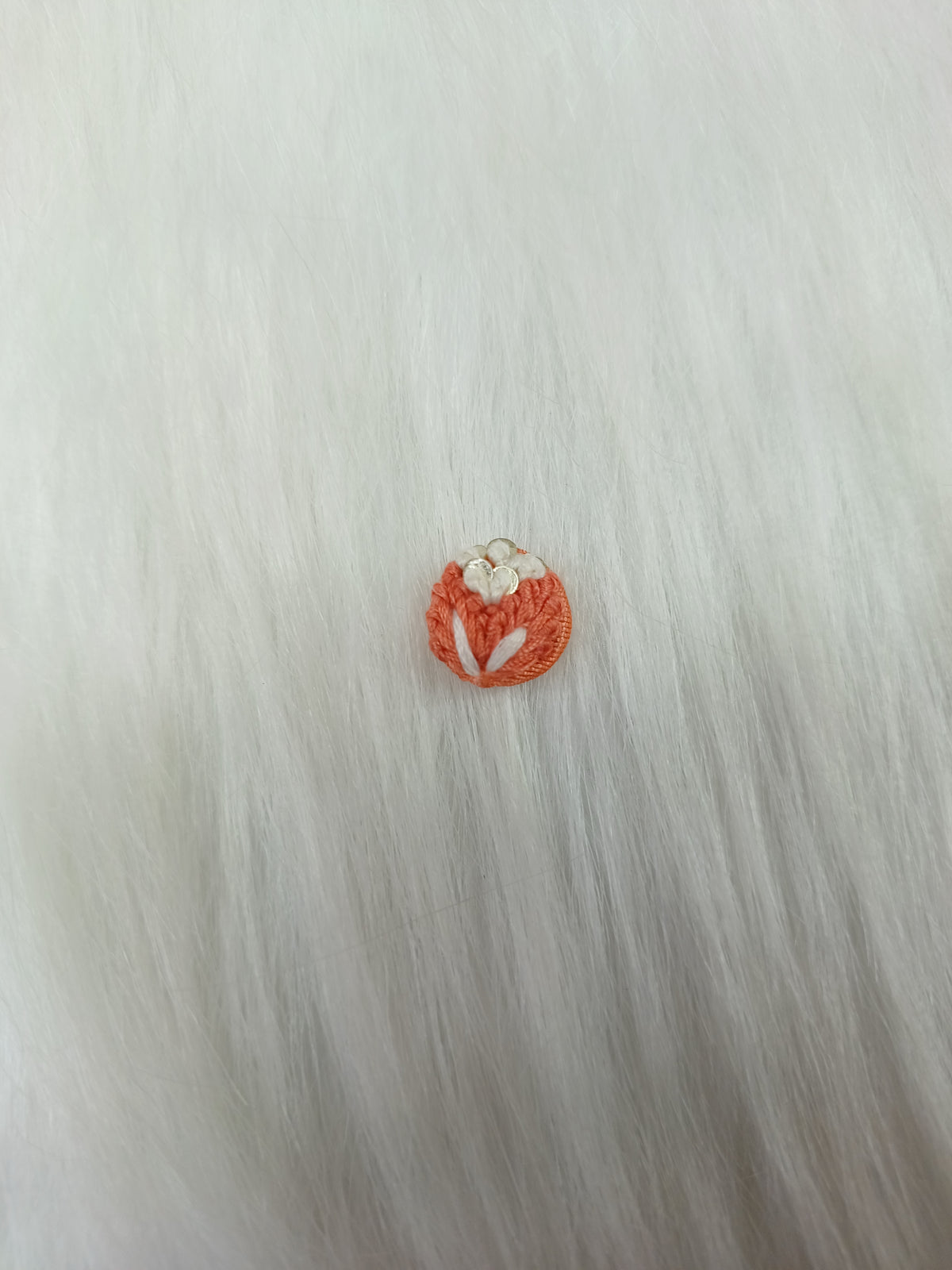 Crochet handwork peach button from Lace Hut featuring intricate design, perfect for adding a handmade touch to garments.