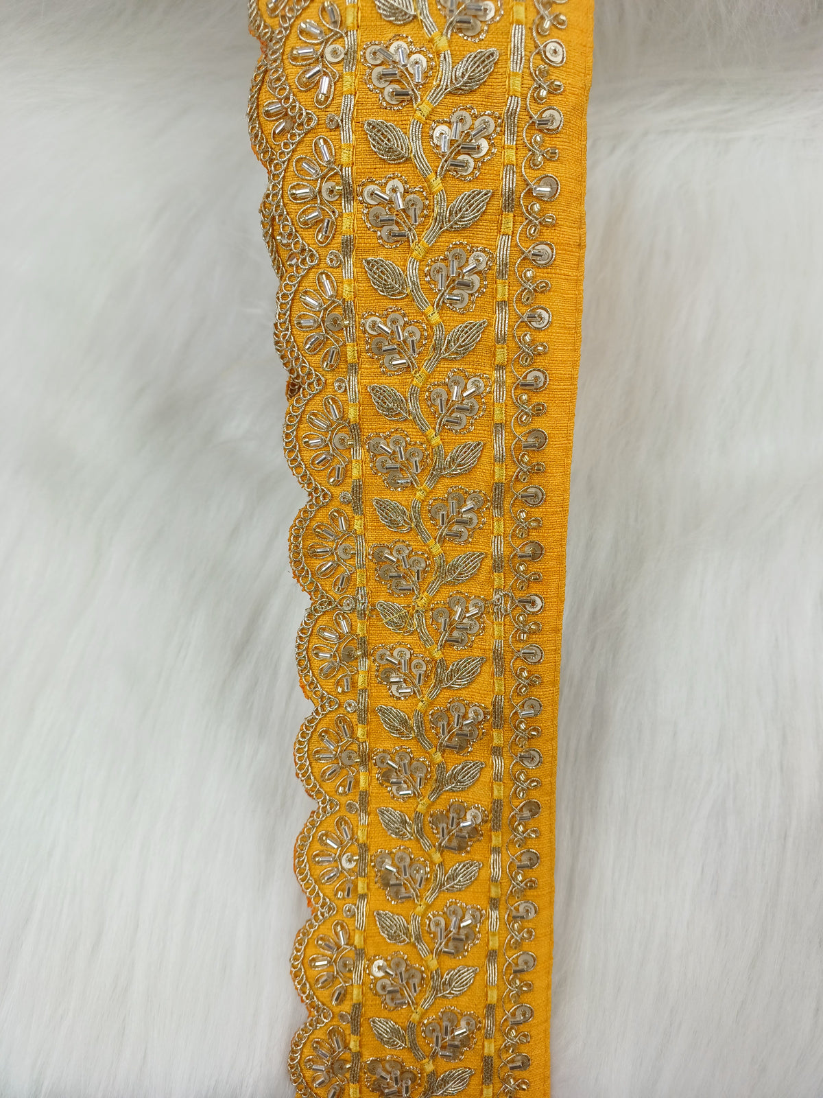 Yellow lace with intricate Cutdana and jari handwork, detailed floral pattern, crafted by Lauce-Hut.
