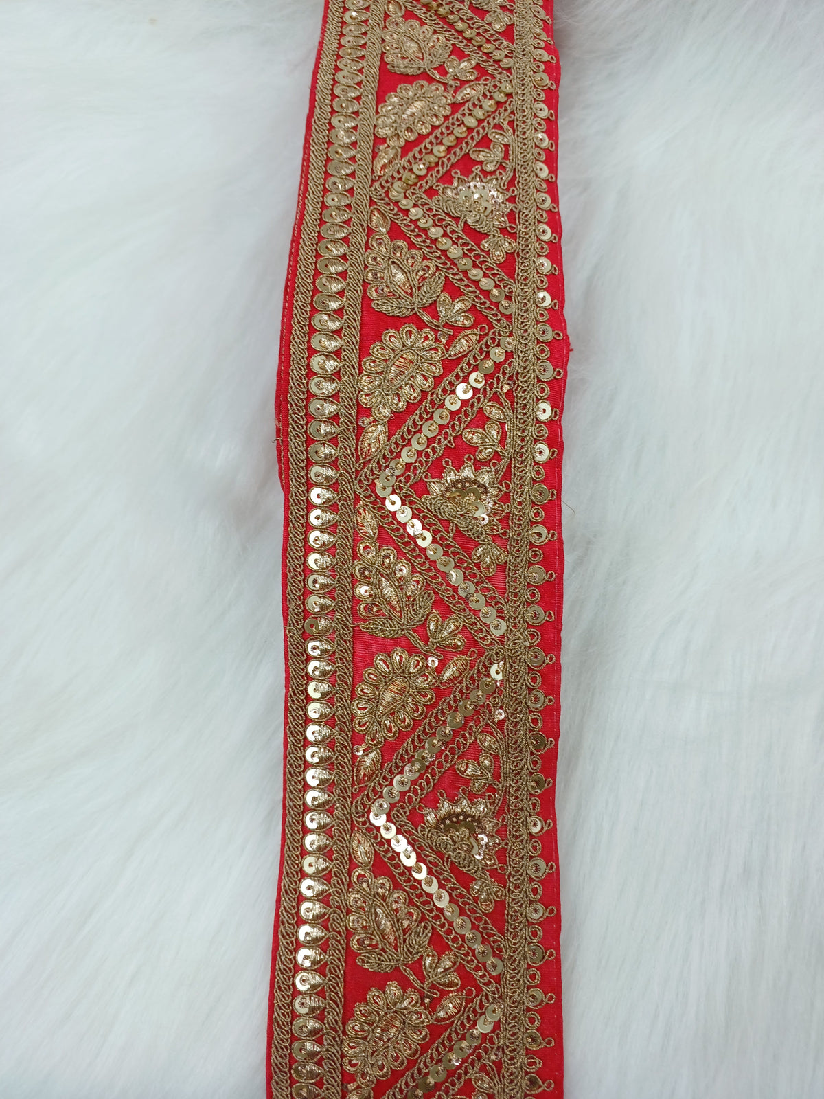 Red Aari work lace fabric from Lauce-Hut featuring intricate embroidery and delicate lace pattern.