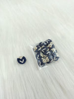 Blue crochet handwork nevi button from Lace Hut with a lacy design and a single button detail.