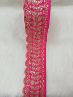 Rani pink lace with cutdana and jari handwork, detailed lace fabric from Lauce-Hut, close-up of intricate embroidery and delicate design.