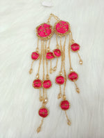 Reddish pink lehenga with Zardosi cutdana and crystal handwork, featuring decorative latkan embellishments.