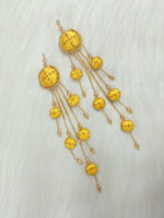 Yellow latkan with Zardosi cutdana and crystal handwork, featuring intricate embroidery and decorative tassels.