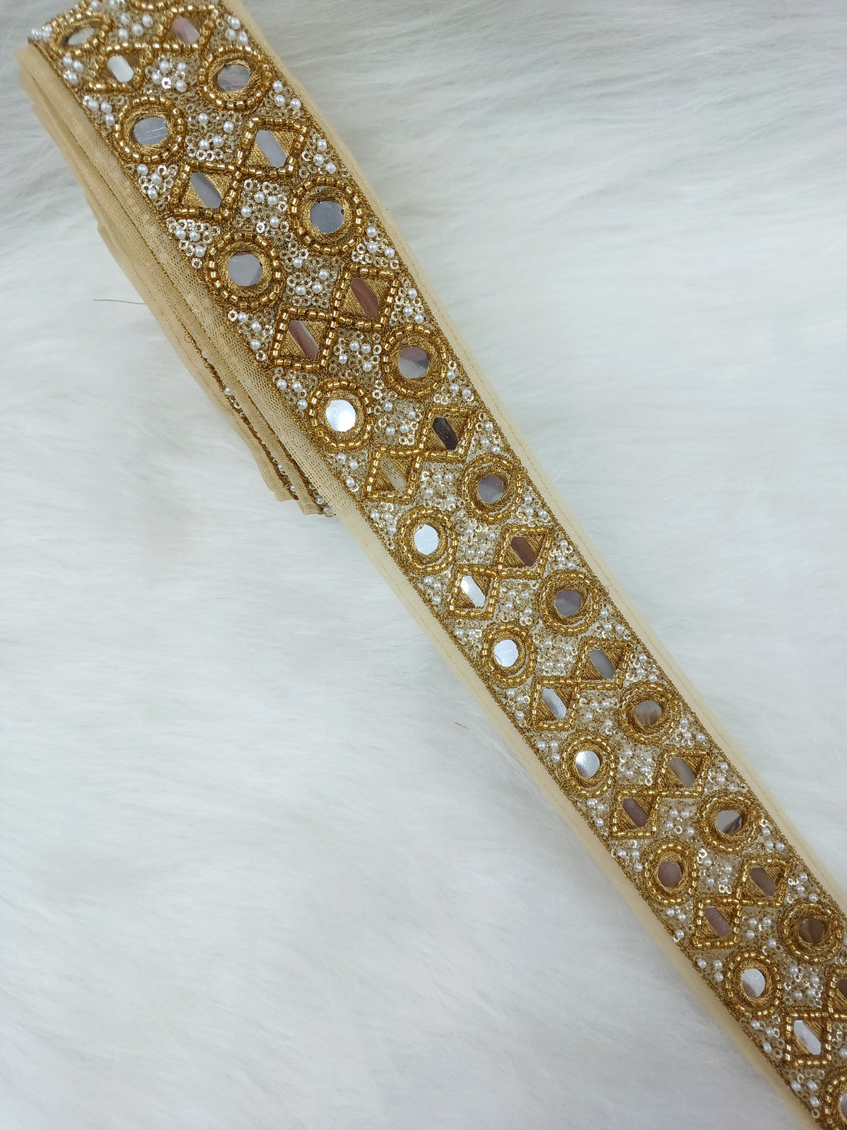 Antique golden cutdana handwork plastic mirror lace with intricate design, showcasing detailed craftsmanship and shiny golden accents.