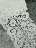 Close-up of intricate flower cut work cotton lace fabric from Xyz, showcasing detailed floral patterns and delicate craftsmanship.