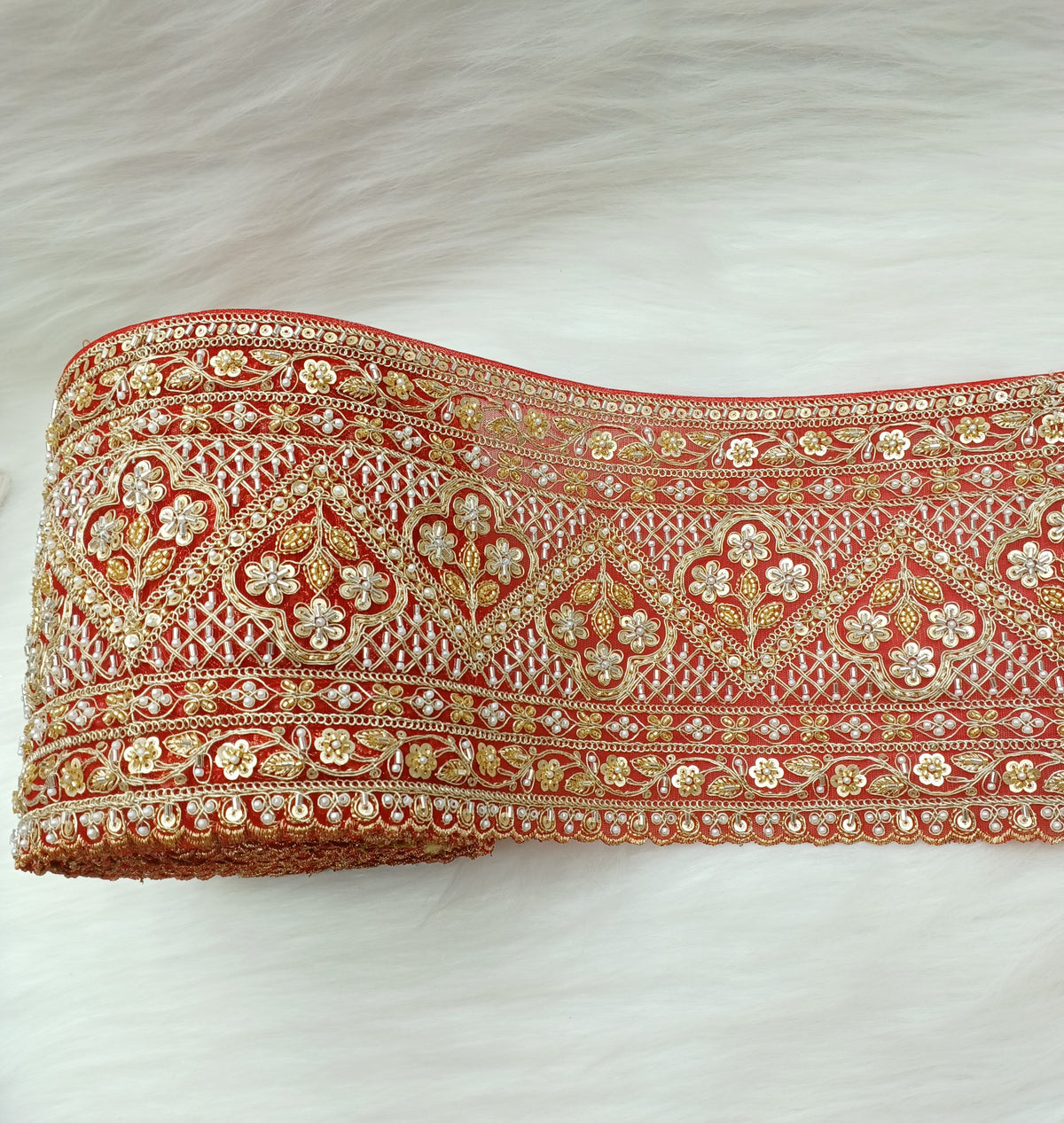 Red lace with intricate cutdana and moti handwork on net base, showcasing detailed embroidery and elegant design by Lace Hut.