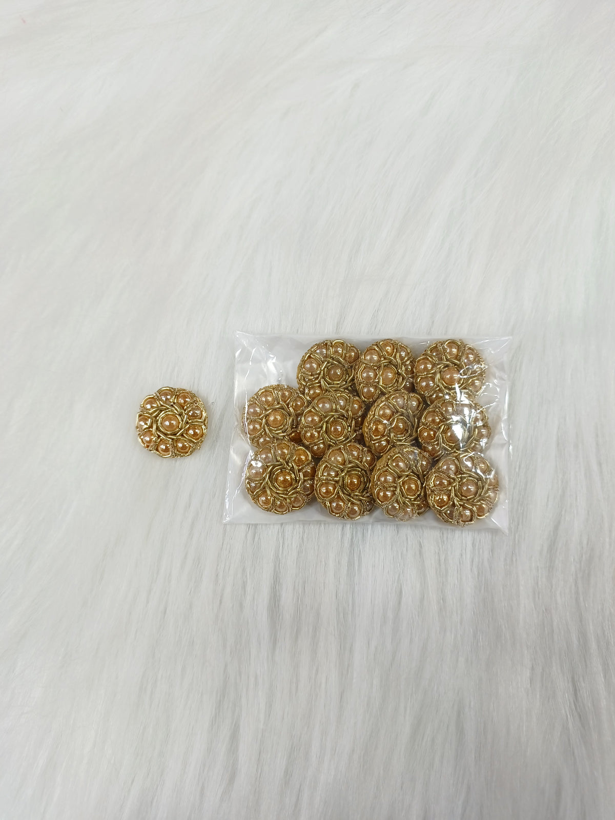 Dull golden Zardosi and moti handwork button with intricate embroidery, designed for traditional Indian garments.