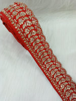 Red lace with intricate cutdana and jari handwork, detailed embroidery by Lauce-Hut, showcasing vibrant, ornate craftsmanship.