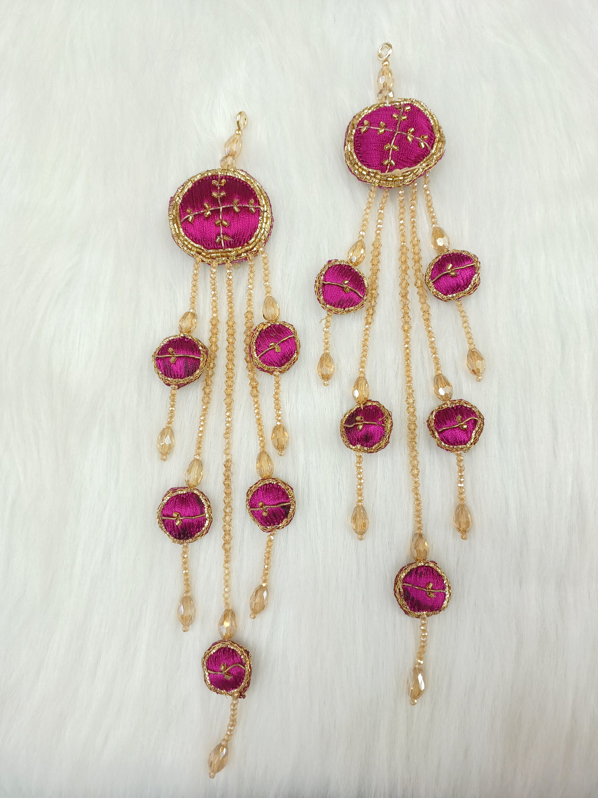 Magenta lehenga latkan with Zardosi cutdana and crystal handwork, featuring intricate embroidery and embellishments.